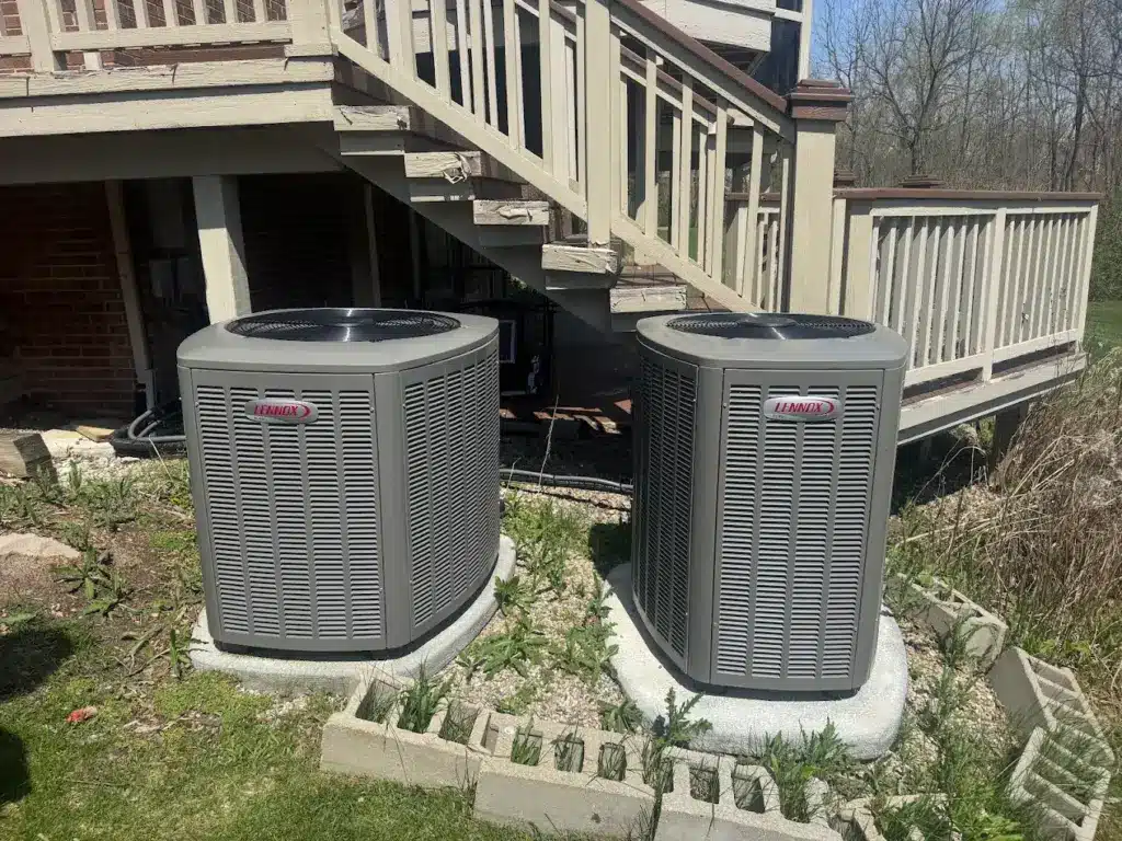Two Lennox air conditioning units installed beside a Michigan home